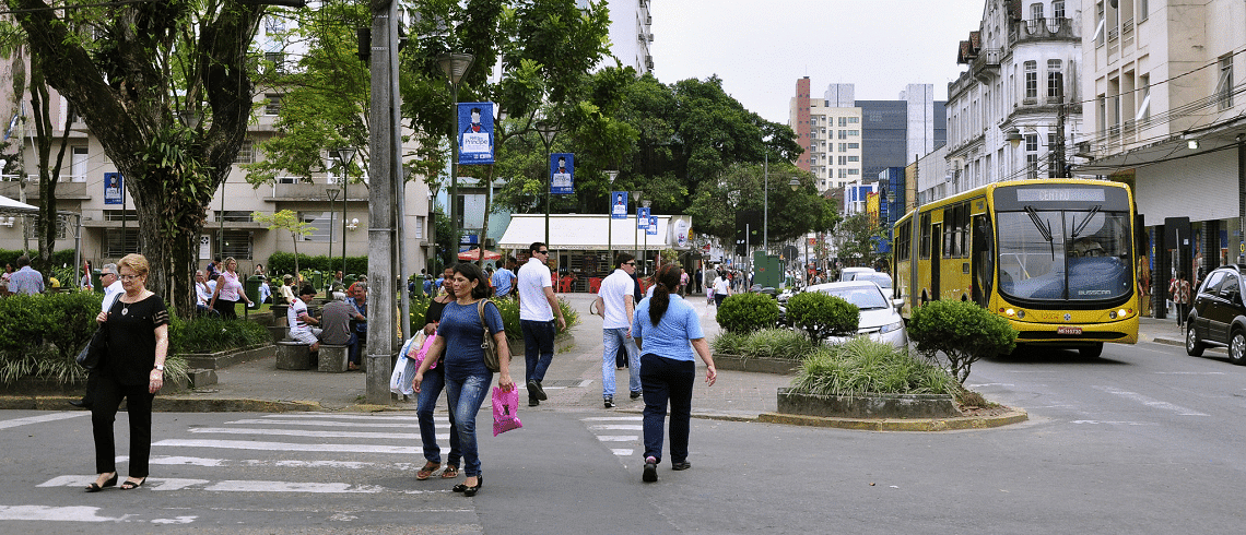 A bus and people walking in the city of Joinville, Brazil